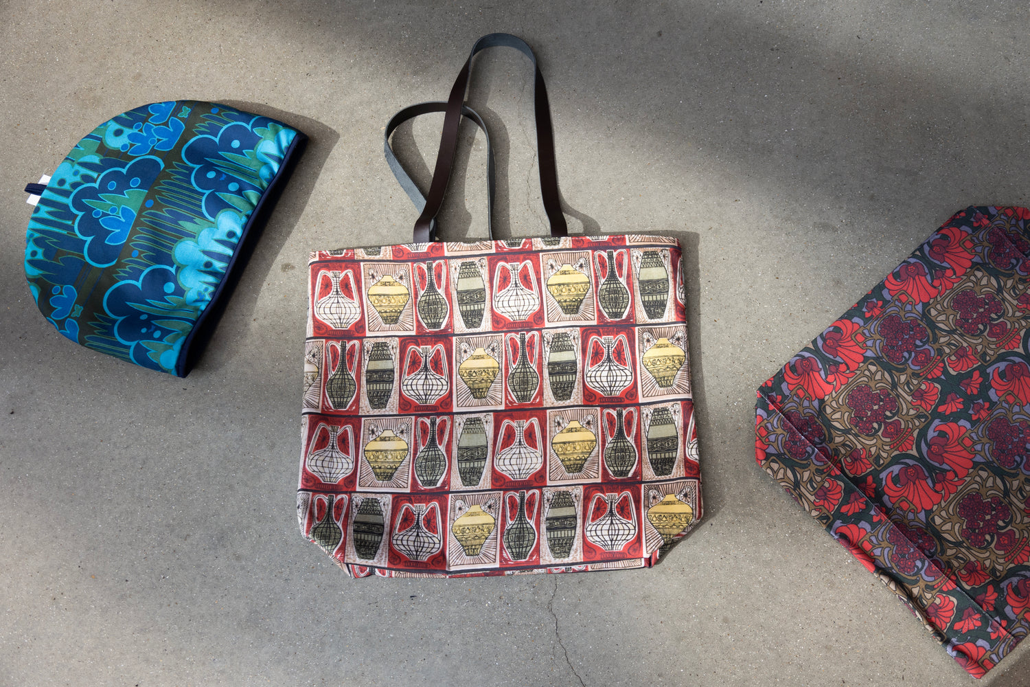 Three patterned bags on a gray surface