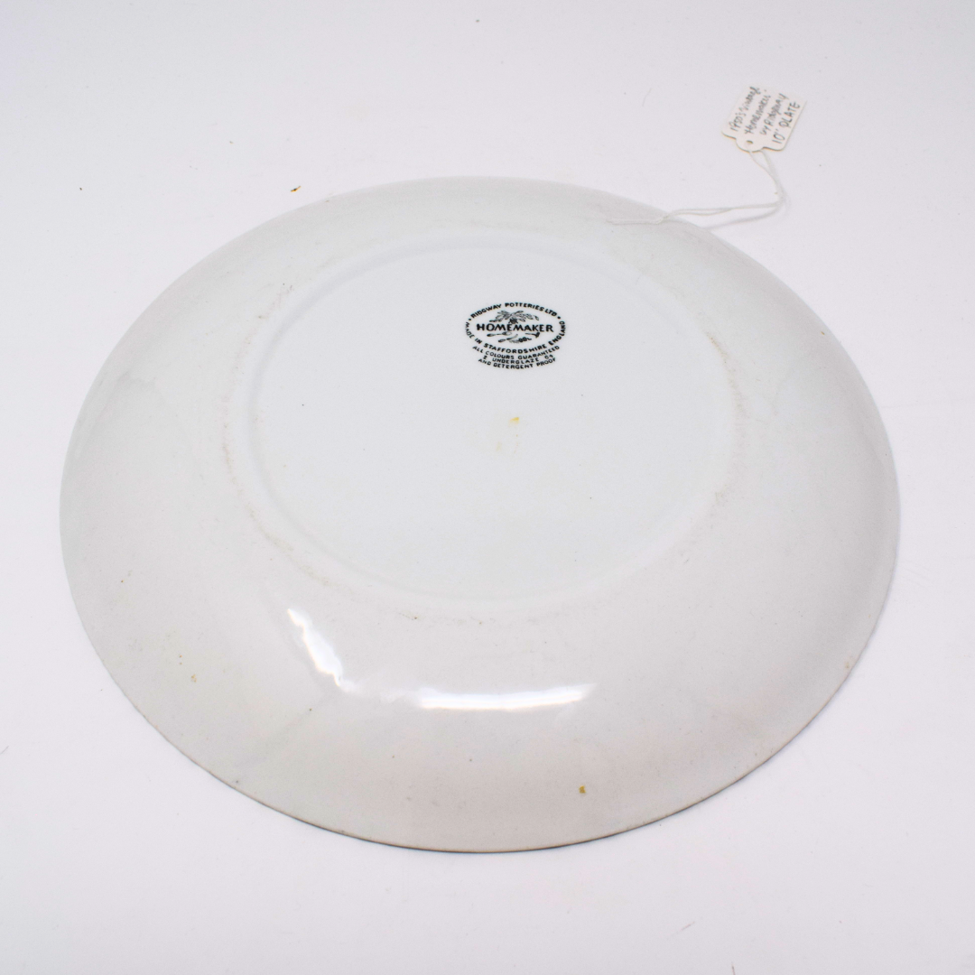 White ceramic plate with a visible brand logo on a white background