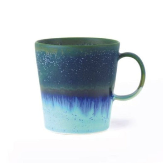 Speckled blue and green mug on a white background
