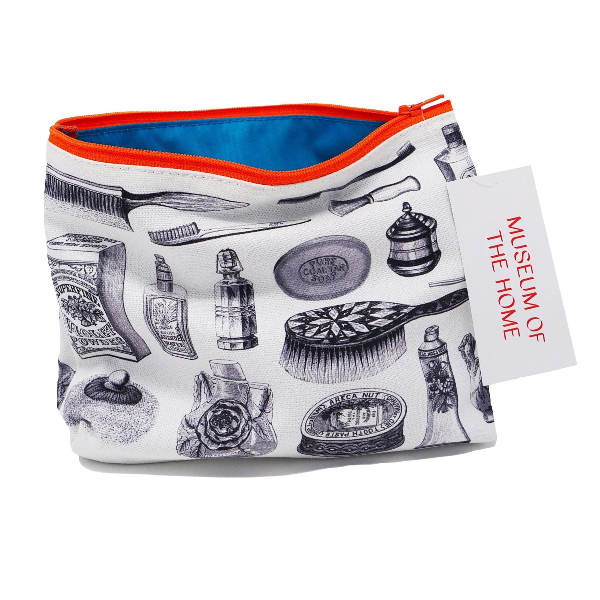 White cosmetics bag printed with illustrations of perfume bottles and hairbrushes in an illustrative style. The bag has an orange zip and a blue lining.