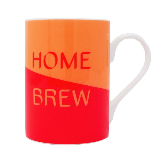 Mug with half orange and half red background separated diagonally, with words Home in red and Brew in orange. Also has white handle.