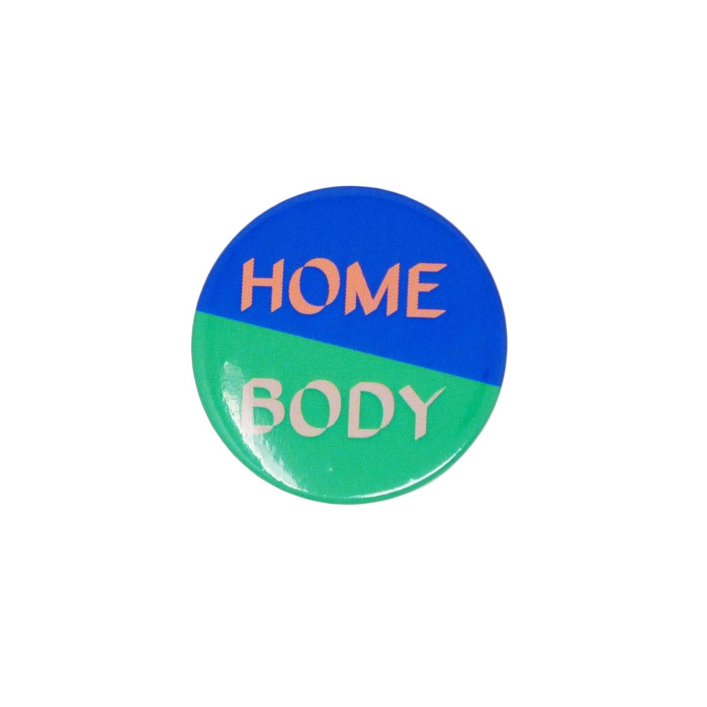 Close up of Home Boy badge with half light green and half dark green background separated diagonally. With 'Home' in peach and 'Body' in light peach font.
