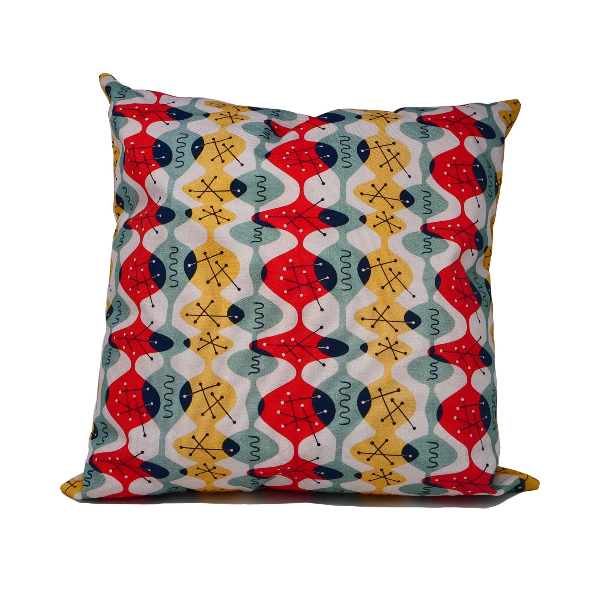 Cushion cover with white background and fluid red, green and yellow ovoid shapes with black atomic structures.