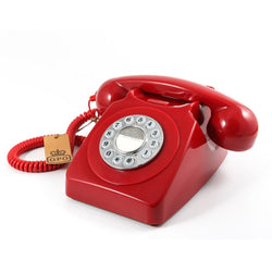 a red vintage rotary dial telephone
