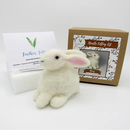 White fluffy bunny toy next to a Needle Felting Kit on a white background