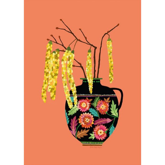 An orange print with an illustration of a black vase with colourful flowers on it. Yellow plants are in the vase.