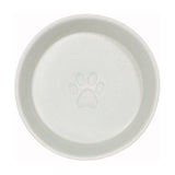 The inside of a dog bowl with a paw in the middle.