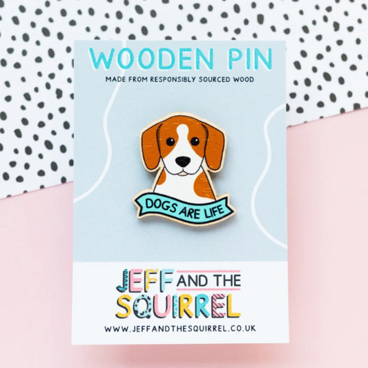 Wooden pin with dog illustration and 'Dogs are Life' text on a card with 'Jeff and the Squirrel' branding.