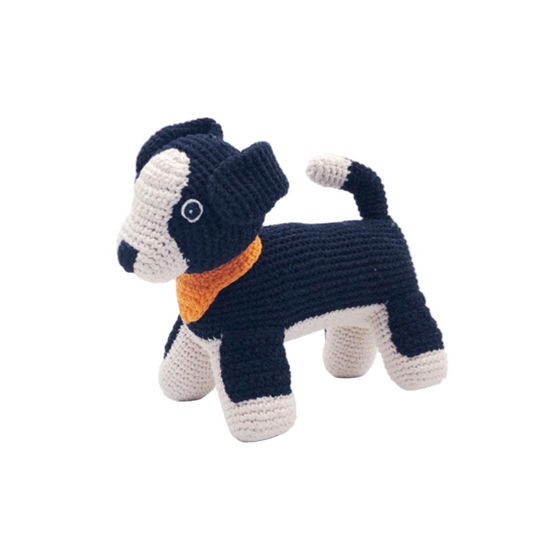 Crocheted dog toy with a black, white, and orange color pattern on a white background
