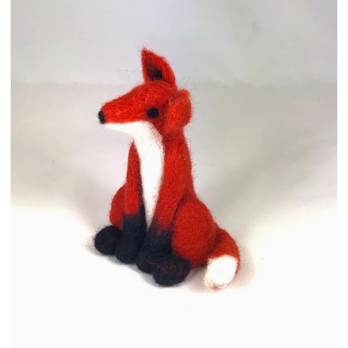 Knitted fox toy on a white background