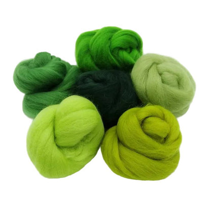Collection of green yarn skeins on a white background