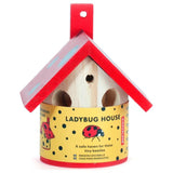 A wooden ladybug house with a red roof.