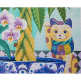 A close up of the print of a lucky cat with flowers and a tree.