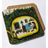 A coaster of an illustrated mouse inside its house. Outside it is green, covered with grass and blue, yellow and red flowers. The back of the coaster can be seen, it is brown.