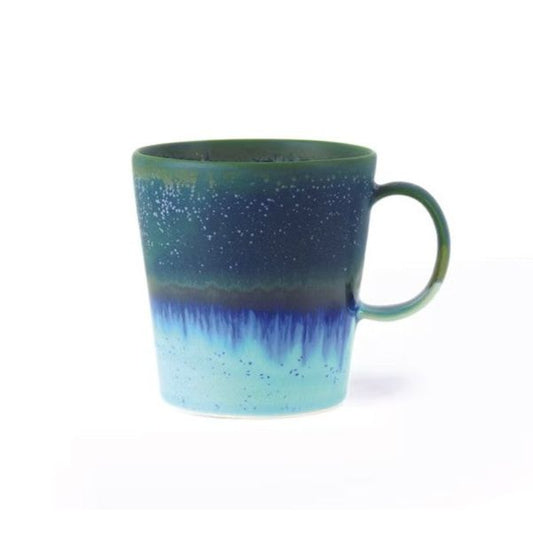 Speckled blue and green mug on a white background
