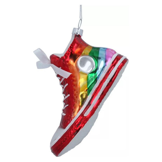 A bauble in the shape of a rainbow coloured sneaker on a white background.