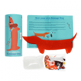 The content of the cylindrical box, including a sausage dog felt piece, thread, plastic needle, stuffing and instructions.