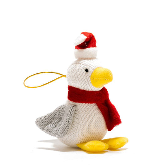 A knitted Christmas duck ornament with a red and white Santa hat, red scarf, yellow beak and feet, and a gold hanging loop, shown on a white background.