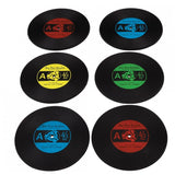 Six record coasters, two of them are red, two are blue, one green and one yellow.