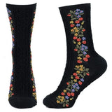 A pair of black socks with embroidered strawberries on the side. One of them is seen from the front where details can be seen.