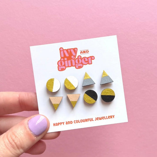 Set of geometric earrings on a 'ivy and ginger' branded card against a pink background
