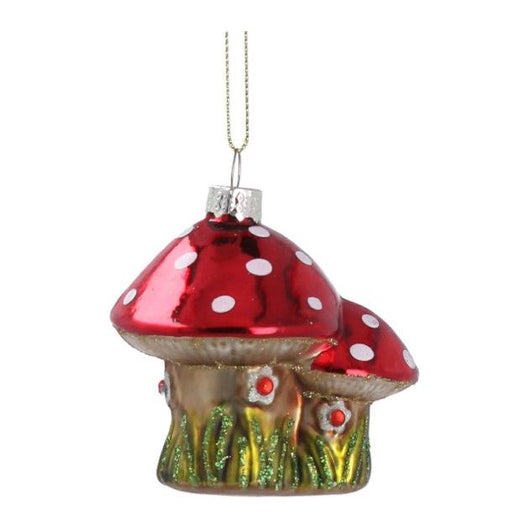 A bauble simulating a big toadstool and a small toadstool beside it. The toadstools are red with white spots and they have got green grass growing on them and small flowers. 