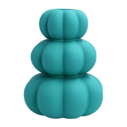 A turquoise stacked vase with circular shapes on a white background.