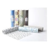A variety of wallpaper rolls in tubes. One is open and laid down, everything is on a white background.