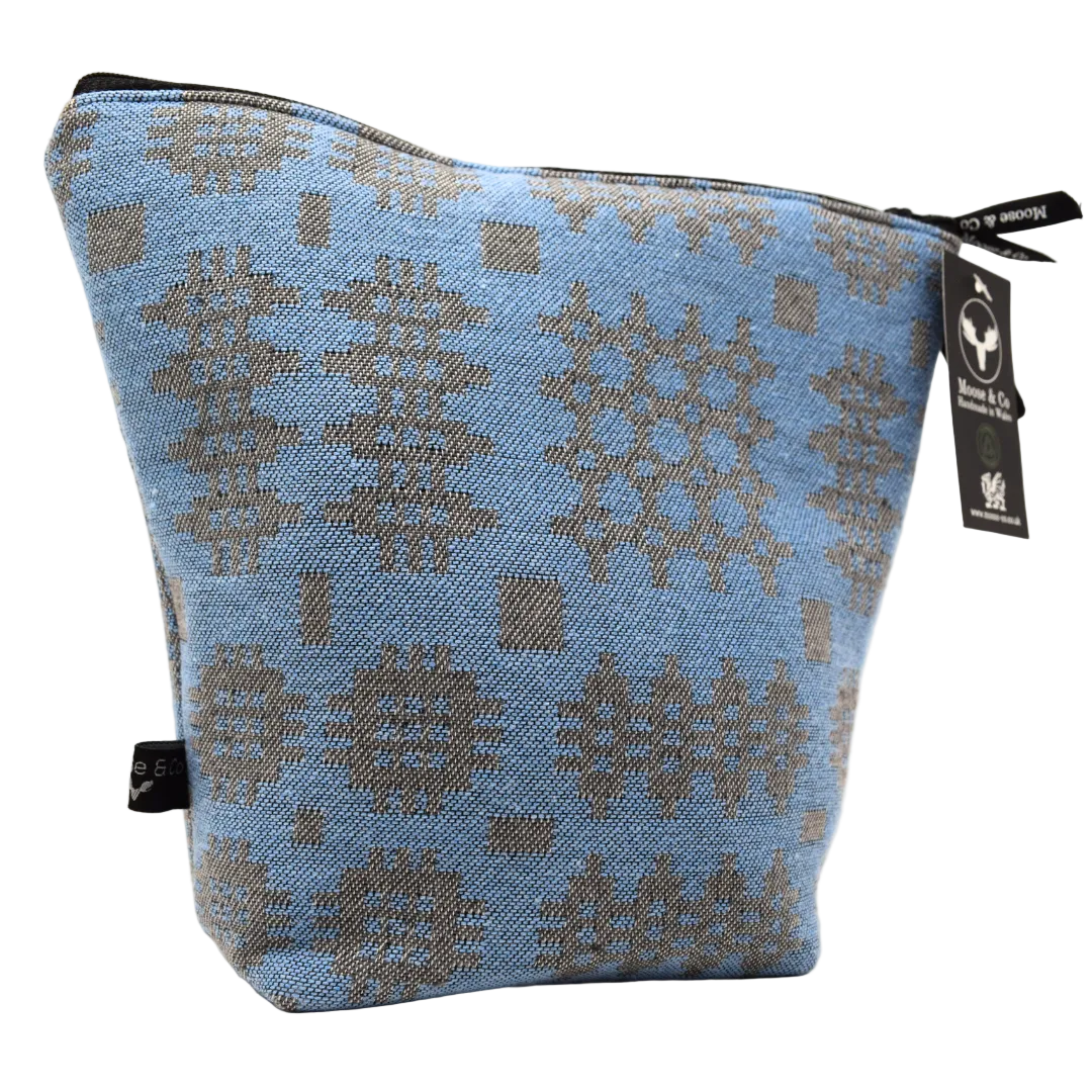 Blue pouch with geometric pattern and visible brand tag on a white background