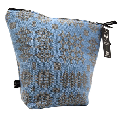 Blue pouch with geometric pattern and visible brand tag on a white background