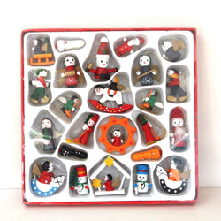 A set of different wooden Christmas figurines. The set includes Santa Claus, angels, snow men, and people on sleights.