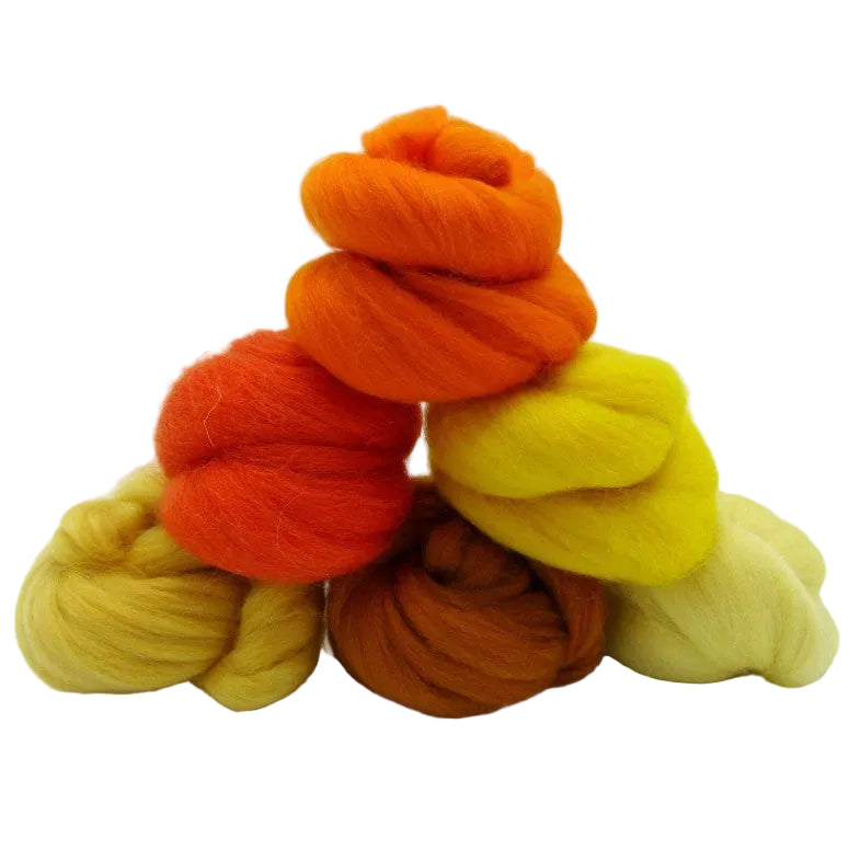 Stack of orange, yellow, and brown yarn on a white background