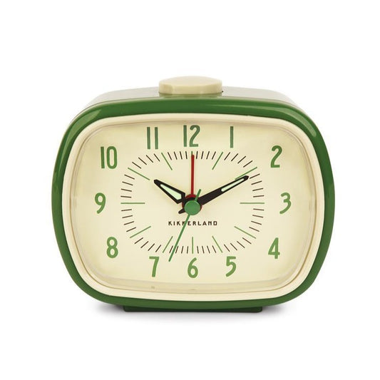 Green and cream alarm clock against a white background. The clock is a rounded square shape with green numbers in a midcentury style.