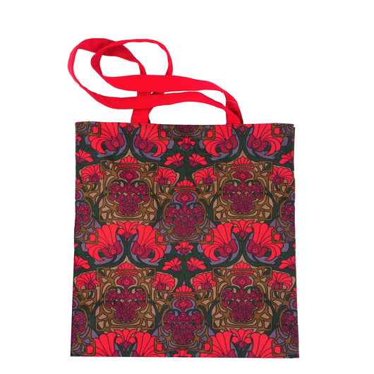 Rectangular shaped box bag with bright red straps, bright red flowers interlaced with dark green stems, brown and blue.