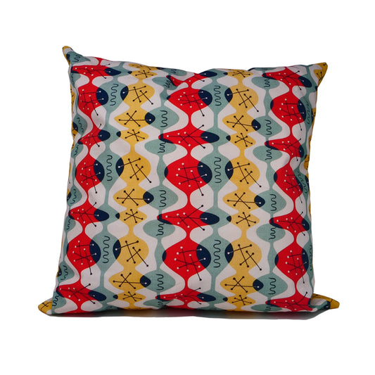 Cushion cover with white background and fluid red, green and yellow ovoid shapes with black atomic structures. 