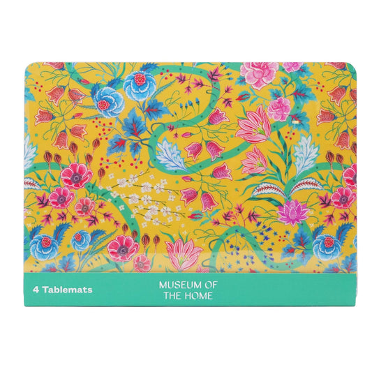 Table mat set showing front tablemat that has yellow background and pink, red and blue flowers with green stems and swirled lines. 