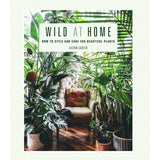 Copy of Wild at Home by Hilton Carter. Title is written in green text on a white background. Cover image shows a room with a ariety of large green pot plants and a cream armchair. Green text below the title reads: "How to style and care for beautiful plants". 