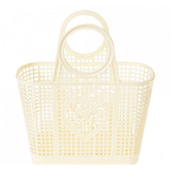 A cream plastic bag with round handles. The basket got open squares and a heart shaped detail in the middle