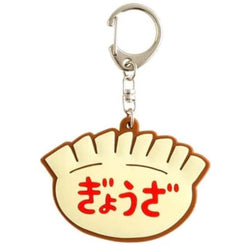A keychain of a plastic dumpling with red details.