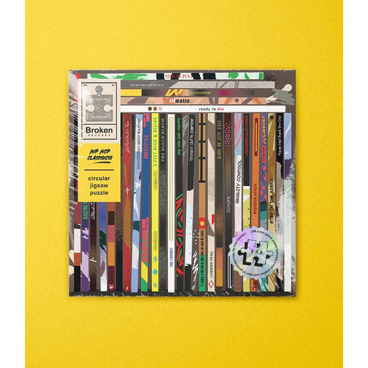 The cover of a jigsaw puzzle with different hiphop records in it on a yellow background.