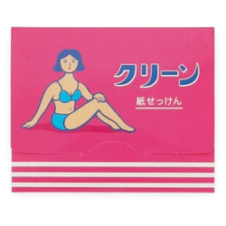 Pink package of paper sheets of soap. The illustration shows a women with short black hair wearing a blue swimming suit.