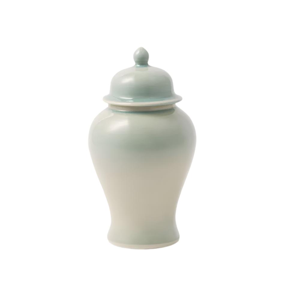 On a white background, a spearmint jar sits in the middle with a same color lid.